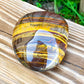 Looking for Large Yellow Tiger Eye Tumbled Stone? Shop at Magic Crystals for Tiger Eye TUMBLED from Africa. Tumbled Tiger Eye also known as a Third Eye, Sacral Chakra gemstone is wonderful for balance, energy healing, and reiki. Tigers Eye Jewelry, Stones, bracelets, necklaces, and more with FREE SHIPPING available.