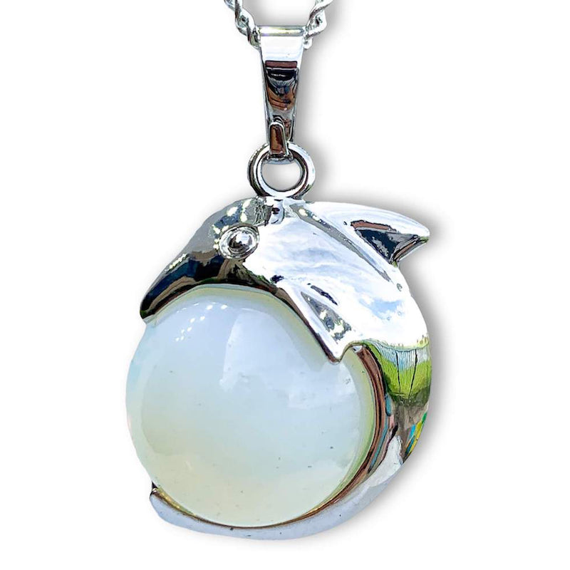 Opalite--Sphere-Dolphin-Pendant-Necklace. Dolphin Necklace - Elegant Ocean-Themed Jewelry for Women Dolphin Charm Necklace at Magic Crystals. Boho Style Jewelry with Natural Gemstones. Stone Carved Dolphin Necklace Pendant, Beach Surf Ocean Boho Gemstone Whale Fairtrade Gift. These beautiful stone necklaces are all hand carved.
