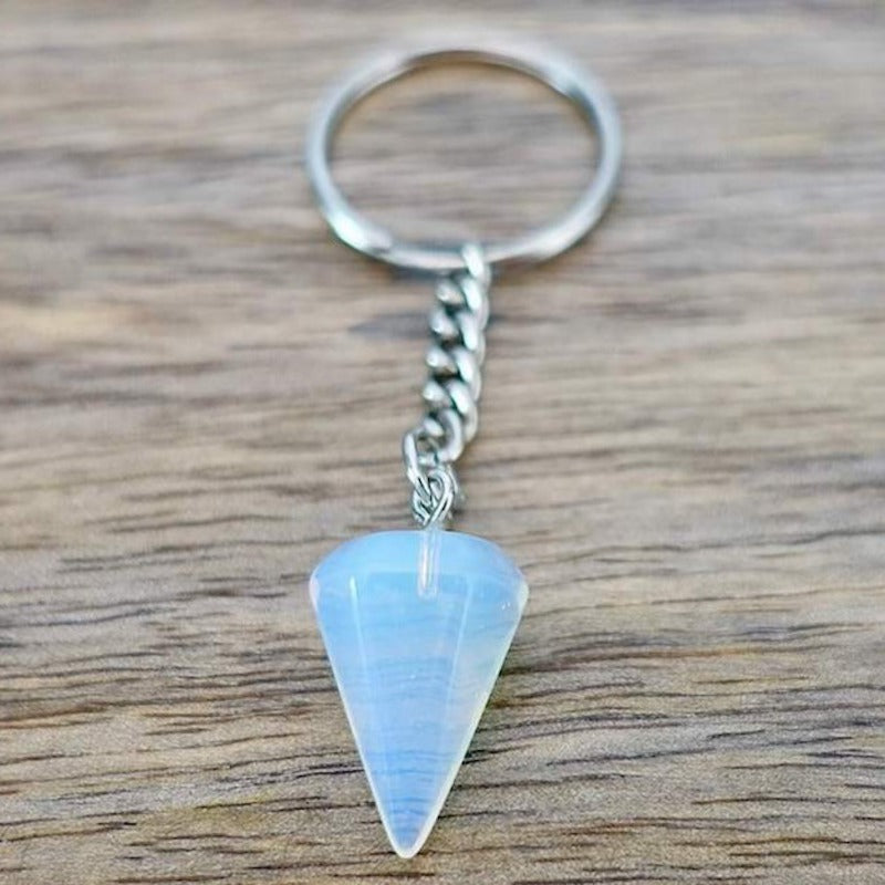 Opalite-Point-Keychain. Opalite KEYCHAIN. Shop at Magic Crystals for Crystal Keychain, Pet Collar Charm, Bag Accessory, natural stone, crystal on the go, keychain charm, gift for her and him. Opalite is a great SPIRITUALITY. FREE SHIPPING available. Opalite Crystal Key Chain, Crystal Keyring, Opalite Crystal Key Holder. Purple stone keys