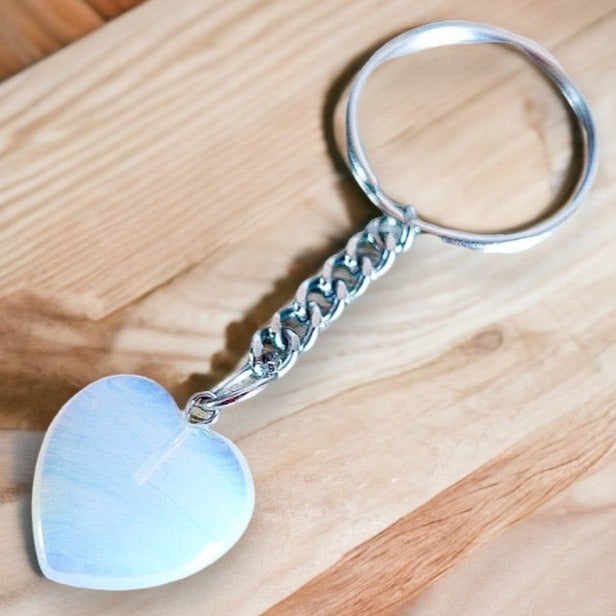 Opalite-Heart-Keychain. Opalite KEYCHAIN. Shop at Magic Crystals for Crystal Keychain, Pet Collar Charm, Bag Accessory, natural stone, crystal on the go, keychain charm, gift for her and him. Opalite is a great SPIRITUALITY. FREE SHIPPING available. Opalite Crystal Key Chain, Crystal Keyring, Opalite Crystal Key Holder. Purple stone keys