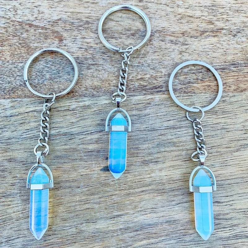 Opalite-Double-Point-Keychain. Opalite KEYCHAIN. Shop at Magic Crystals for Crystal Keychain, Pet Collar Charm, Bag Accessory, natural stone, crystal on the go, keychain charm, gift for her and him. Opalite is a great SPIRITUALITY. FREE SHIPPING available. Opalite Crystal Key Chain, Crystal Keyring, Opalite Crystal Key Holder. Purple stone keys