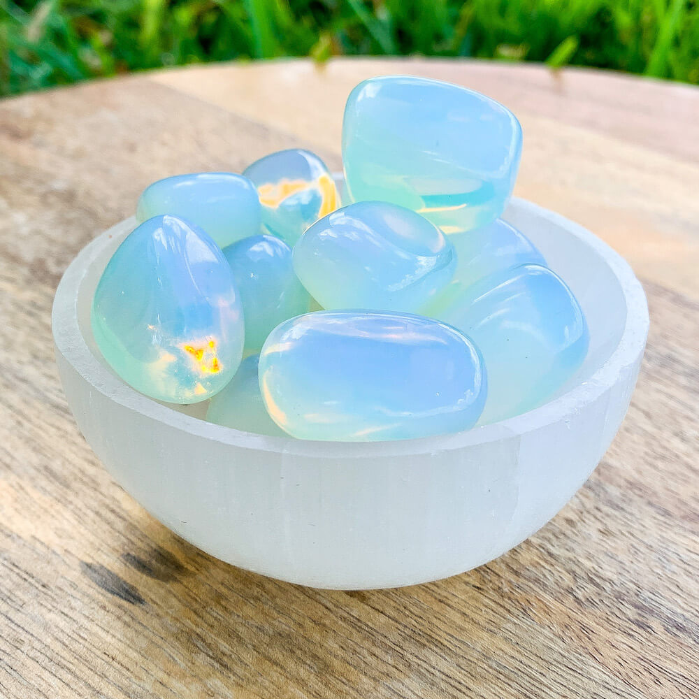 Buy Opalite Tumbled Stones | Opalite Polished Gemstones | Bulk Crystals at Magic Crystals. Opalite Jewelry with FREE SHIPPING available. Opalite is a stone of emotional balance. Opalite improves your sense of self-worth, assists in making smooth transitions & also useful in helping success in business.