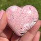 Shop for handmade Pink Rhodonite heart -  Peruvian Rhodonite Carved Heart at Magic Crystals. Rhodonite Polished Heart Healing Crystal Gemstone. Rhodonite is a wonderfully peaceful crystal. Enjoy FREE SHIPPING when you shop at magiccrystals.com