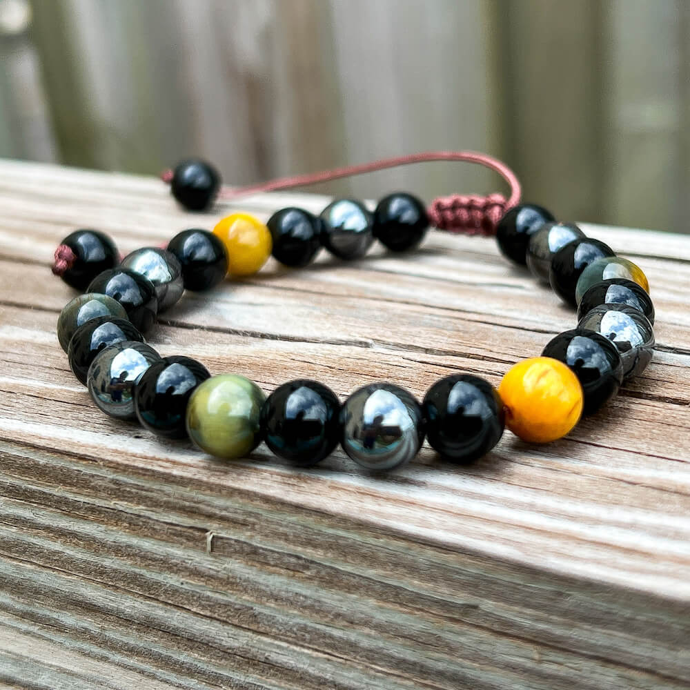 Looking for a protection bracelet? Shop at Magic Crystals for Yellow Tiger Eye, Hematite, and Black Obsidian Bracelet. Bracelet made of natural gemstones and Lava stones for Oils Diffuser. Unisex jewelry adjustable bracelet. Color: Black and metallic, gray for Chakra: Third Eye, Solar Plexus, Sacral, Root. FREE SHIPPING
