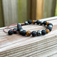 Looking for a protection bracelet? Shop at Magic Crystals for Yellow Tiger Eye, Hematite, and Lava Stone Bracelet. Bracelet made of natural gemstones and Lava stones for Oils Diffuser. Unisex jewelry adjustable bracelet. Color: Black and metallic, gray for Chakra: Third Eye, Solar Plexus, Sacral, Root. FREE SHIPPING