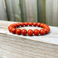 Looking for Red Jasper Jewelry? Shop at Magic Crystals for Red Jasper Beaded Bracelets. Natural Red Jasper Unisex Elastic Bracelet. Red jasper is a stone of physical strength, a vitality that can help with the stabilization of one’s energy. FREE SHIPPING available. Natural Healing Gemstone Buddha Charm Bracelet, red jasper earrings, and rings.