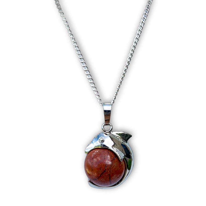    Red-Jasper--Sphere-Dolphin-Pendant-Necklace. Dolphin Necklace - Elegant Ocean-Themed Jewelry for Women Dolphin Charm Necklace at Magic Crystals. Boho Style Jewelry with Natural Gemstones. Stone Carved Dolphin Necklace Pendant, Beach Surf Ocean Boho Gemstone Whale Fairtrade Gift. These beautiful stone necklaces are all hand carved.