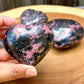 Looking for Rhodonite Heart Carving? Shop for handmade Rhodonite heart, Rhodonite Carved Heart - Rhodonite Stone at Magic Crystals. Rhodonite Polished Heart Healing Crystal Gemstone. Rhodonite is a wonderfully peaceful crystal. Enjoy FREE SHIPPING when you shop at magiccrystals.com