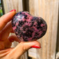 Shop for handmade Rhodonite heart, Rhodonite Carved Heart - Rhodonite Stone at Magic Crystals. Rhodonite Polished Heart Healing Crystal Gemstone. Rhodonite is a wonderfully peaceful crystal. Enjoy FREE SHIPPING when you shop at magiccrystals.com