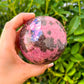 Shop for handmade Rhodonite Sphere, Rhodonite Carved Sphere - Rhodonite Stone at Magic Crystals. Rhodonite Polished Sphere Healing Crystal Gemstone. Rhodonite is a wonderfully peaceful crystal. Enjoy FREE SHIPPING when you shop at magiccrystals.com
