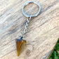 TIGER EYE KEYCHAIN. Tiger Eye may also bring good luck to the wearer. Tiger Eye Stone Single Point Keychain, Point Keychains at Magic crystals. Free shipping available. We carry a wide variety of cat eyes keychains, gemstones, bracelets, earrings and handmade jewelry.