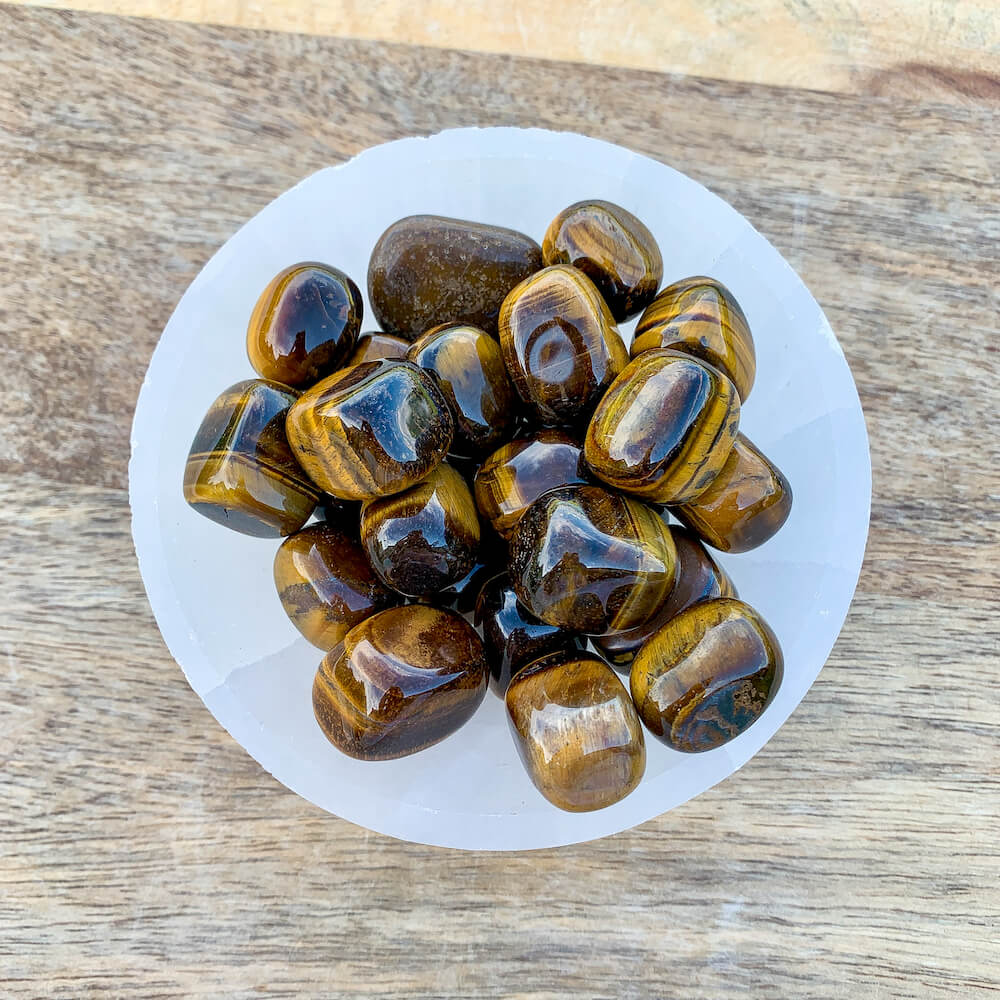 Looking for Yellow Tiger Eye Tumbled Stone? Shop at Magic Crystals for Tiger Eye TUMBLED from Africa. Tumbled Tiger Eye also known as a Third Eye, Sacral Chakra gemstone is wonderful for balance, energy healing, and reiki. Tigers Eye Jewelry, Stones, bracelets, necklaces, and more with FREE SHIPPING available.
