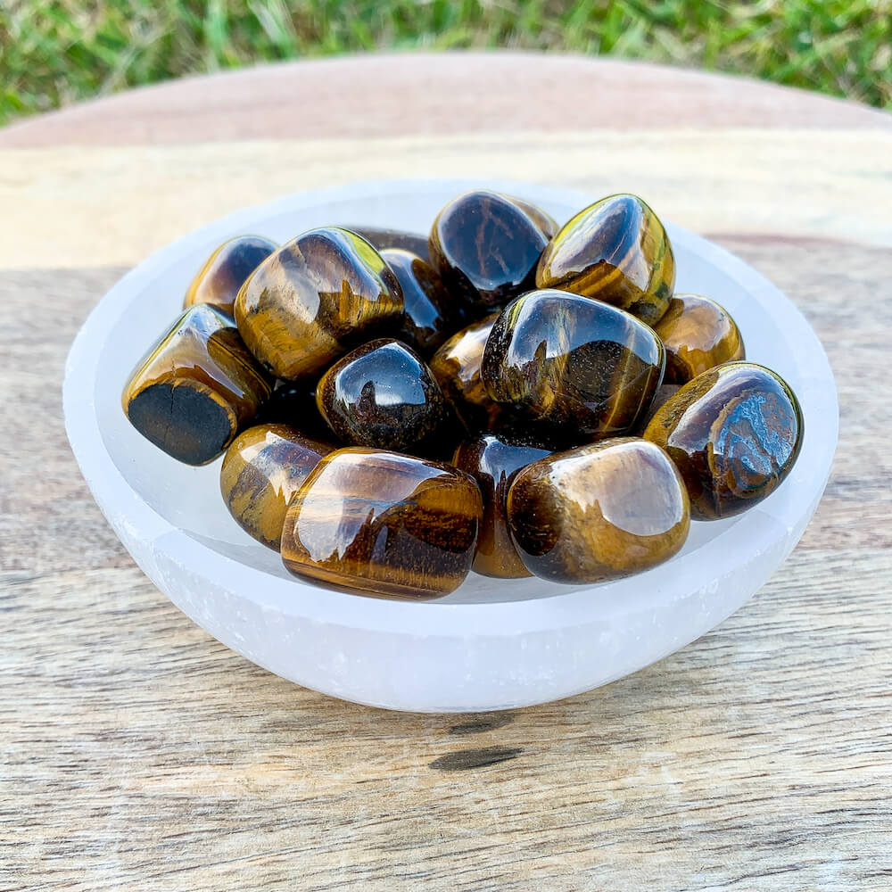 Looking for Yellow Tiger Eye Tumbled Stone? Shop at Magic Crystals for Tiger Eye TUMBLED from Africa. Tumbled Tiger Eye also known as a Third Eye, Sacral Chakra gemstone is wonderful for balance, energy healing, and reiki. Tigers Eye Jewelry, Stones, bracelets, necklaces, and more with FREE SHIPPING available.