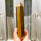 Looking for Natural Yellow Tiger Eye Obelisk? Shop at Magic Crystals for Tiger Eye Tower. Yellow Tiger Eye is a stone of protection and good luck. Natural Tiger Eye Crystal, Tiger Eye Point Wand, Generator Hexagonal Point (Reiki Healing Wand Point), Gemstone Wand.