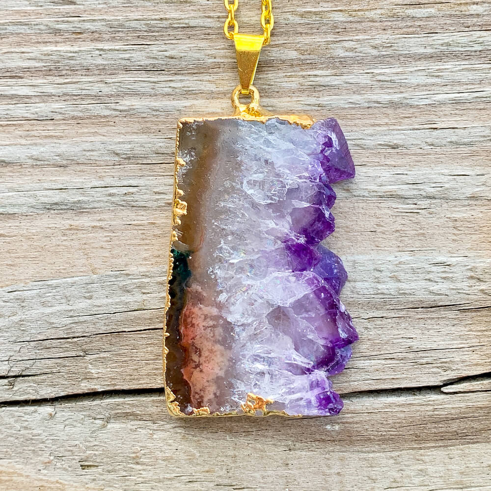 Looking for Raw Amethyst Gold Plated Handmade Pendant Necklace? Shop at Magic Crystals for Amethyst Jewelry. Amethyst Stone necklaces are good for PROTECTION, PURIFICATION, and SPIRITUALITY. Raw Amethyst Slice Pendant February Birthstone Necklace Gold Filled Chain Rectangle. Purple Crystal Gift. Handmade Jewelry.